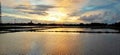 Sunset reflection looks distort due to wind creating water movement at paddy field