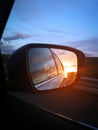 Sunset reflection in the mirror of a car Royalty Free Stock Photo