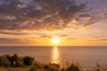 Sunset reflection ocean. beautiful sunset behind the clouds and blue sky above the over ocean landscape background Royalty Free Stock Photo