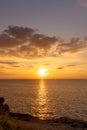 Sunset reflection ocean. beautiful sunset behind the clouds and blue sky above the over ocean landscape background Royalty Free Stock Photo