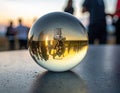 Sunset Reflections: A Glass Sphere Captures the Golden Hour and Distant Silhouettes Royalty Free Stock Photo