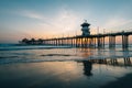 Sunset reflections and the pier in Huntington Beach, Orange County, California Royalty Free Stock Photo