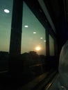 Sunset Reflections on Train Window during Evening Journey Royalty Free Stock Photo