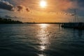 Sunset with reflections in the water in the port of the river Trave in Lubeck Travemunde at the Baltic sea, cloudy orange sky and Royalty Free Stock Photo