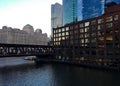 Sunset reflects on building windows and over a freezing Chicago River during winter evening rush hour. Royalty Free Stock Photo