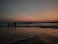 sunset reflects over the Arabian sea at beach