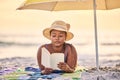 Sunset, relax or black woman reading book at ocean for alone time, rest break or holiday vacation. Beach, travel or Royalty Free Stock Photo