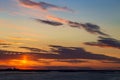 Sunset on the river. Colorful landscape with river and blue sky with multicolored clouds. River sunset panorama Royalty Free Stock Photo