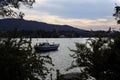 Sunset River Landscape with Boat, Alps, Bushes and Colorful Sky in Zurich, Switzerland