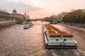 Sunset river sena paris, with boats and bridges in the background.