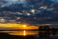 Sunset on the river with three trees on Desna river in springtime, Ukraine. Royalty Free Stock Photo