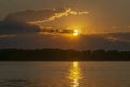 Sunset on the river Volga. In the distance are the mountains Zhiguli. Golden path is reflected in the water. Royalty Free Stock Photo