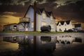 Sunset road puddle reflection of rustic beach homes on the Avalon peninsula Royalty Free Stock Photo