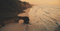 Sunset at rock wall on sand beach aerial view. Nobody nature scenery of ocean seascape with waves Royalty Free Stock Photo