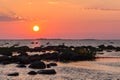 Sunset rocky beach, peaceful sea, orange sky. Kihnu, small island in Estonia. Baltic sea, Europe. Natural environment background Royalty Free Stock Photo