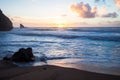 Sunset at rocky coastline of Adraga beach