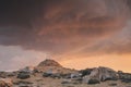 Sunset at rocky desert with a red cloudy sky