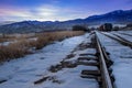 Sunset in the Rocky Mountains with train tracks in the snow Royalty Free Stock Photo