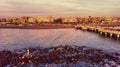 Sunset Rome aerial view at Ostia Lido beach from sea over cliff and ruin of Neptune statue with city skyline with downtown Royalty Free Stock Photo