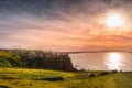 Sunset at ruins of Dunluce Castle, perched on the cliff, Northern Ireland Royalty Free Stock Photo