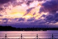 Dark sky with colorful clouds over water. Royalty Free Stock Photo