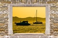 Sunset sailing and yachting through stone wall door