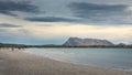 Sunset on San Teodoro sand beach with turquoise sea water and mountains of island Tavolara in Sardinia Italy Royalty Free Stock Photo