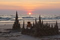 Sunset with sand castles and a dog Royalty Free Stock Photo