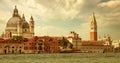 Santa Maria della Salute Basilica, St. Mark`s campanile and waterfront in Venice, Italy