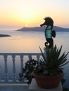 Sunset at Santorini. Seahorse sculpture at house terrace. Santorini caldera, Greece.Europe. Aegean sea. Royalty Free Stock Photo