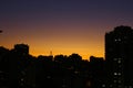 Sunset in Sao Paulo city. Building silhouette. Little windows are coming up with the night Royalty Free Stock Photo