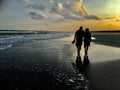 Couple Walking On The Beach