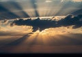Sunset scene with dramatic crepuscular rays streaming through clouds Royalty Free Stock Photo