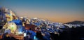 The sunset scene of tourist destination Oia village  in the night with traditional white houses and windmills in Santorini island Royalty Free Stock Photo