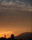 Sunset scenery with palm tree and hills, dessert like Royalty Free Stock Photo