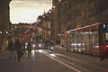 Sunset scenes from the center of Bern with people on the street, tourist sights and legendary trams or buses.