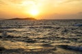 Sunset scenic powerful windy moving sea wave view with light reflection and beautiful shades of wide orange color sky background