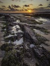 Sunset on scenic rocky beach in Freshwater West, South Wales, UK Royalty Free Stock Photo