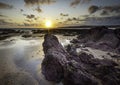 Sunset on scenic rocky beach in Freshwater West, South Wales, UK