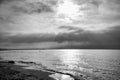 Sunset at the sea in black and white dreamy. Sandy beach in the foreground Royalty Free Stock Photo