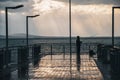 Sunset on a sea bridge after rain in Bulgaria. Reflections on ground. Amazing sea landscape. Fisherman waiting for fish. Royalty Free Stock Photo