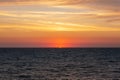 Sunset on the sea in the clouds with sun rays