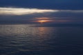Sunset and sea. Evening landscape of blue cloudy sky and dark sea Royalty Free Stock Photo