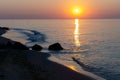 Sunset at the sea. Evening sun and path. Beautiful sky and clouds. Landscape on the coast. Ocean shore. Dawn. Nature