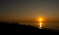 Sunset at the sea. Evening sun and path. Beautiful sky and clouds. Landscape on the coast. Ocean shore. Dawn. Nature