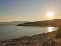 Sunset on sea and green hills surrounding