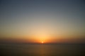 Sunset on sea panorama orange small sun