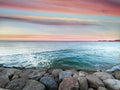 Exotic  sunset on sea ,pink blue clouds  horizon ,emerald green sea wave water splash on stones  ,nature landscape tropical island Royalty Free Stock Photo