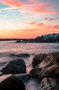 Sunset at sea with rocks in the foreground