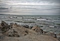 Sunset at the sea shore of a beach with rocks and stormy waves, beautiful seascape at Caspian sea Absheron, Azerbaijan Novkhani Royalty Free Stock Photo